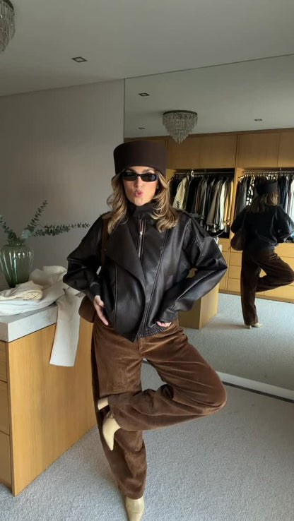 Faux leather jacket with brown collar detail.