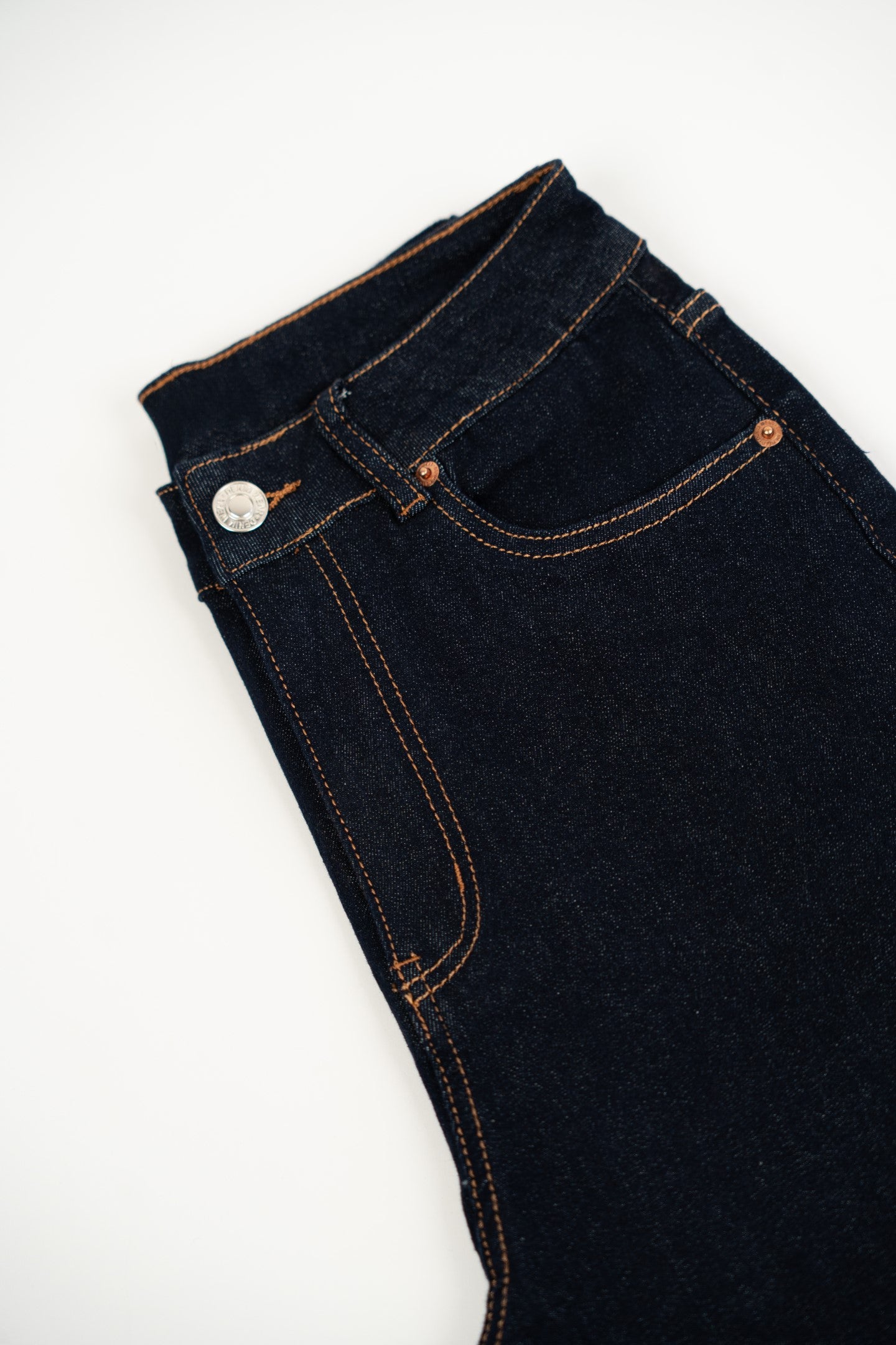 Ciemne dżinsowe spodnie z zakładką.