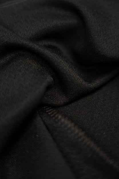 Long black dress with gold choker.