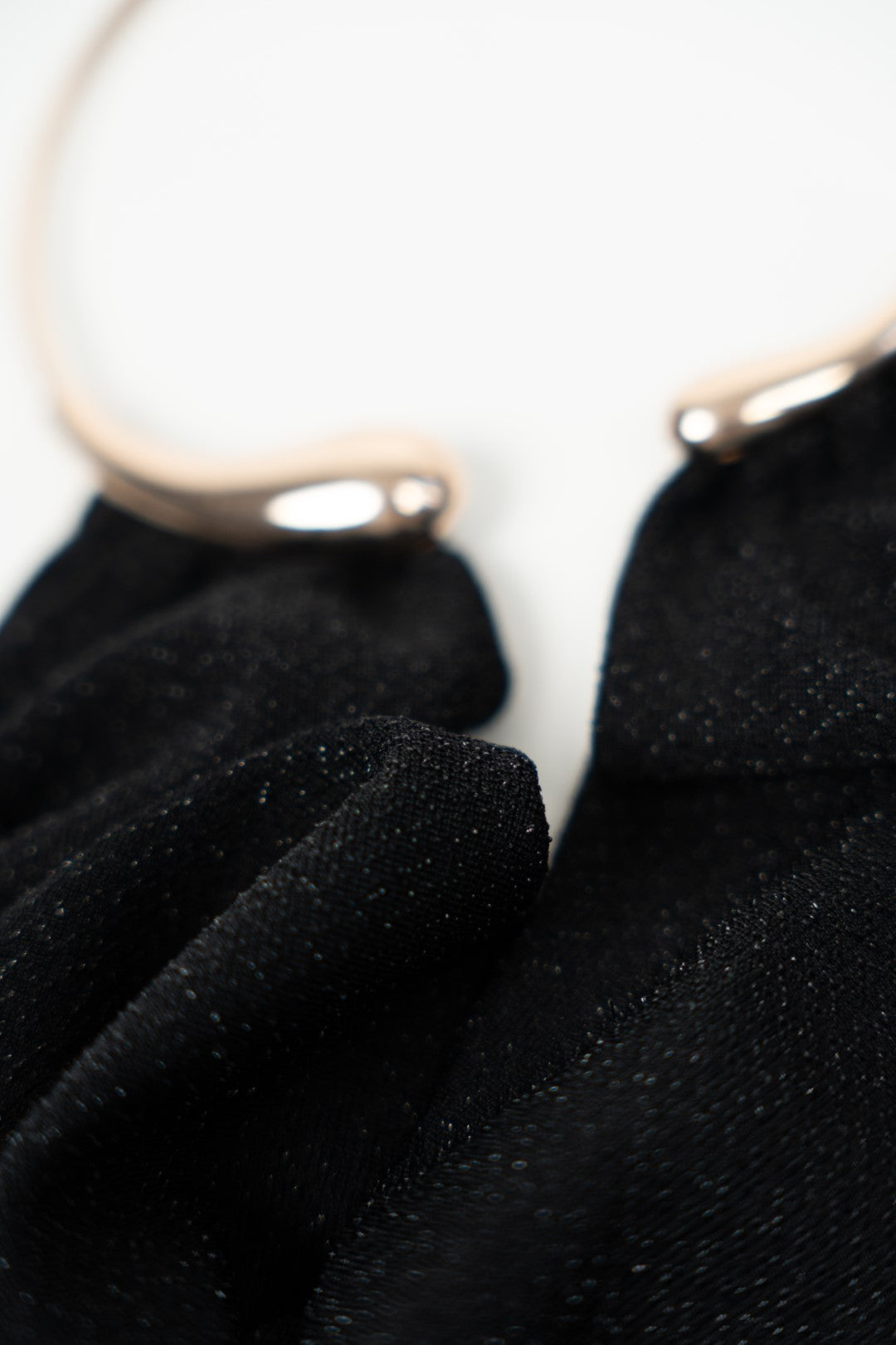 Long black dress with gold choker.