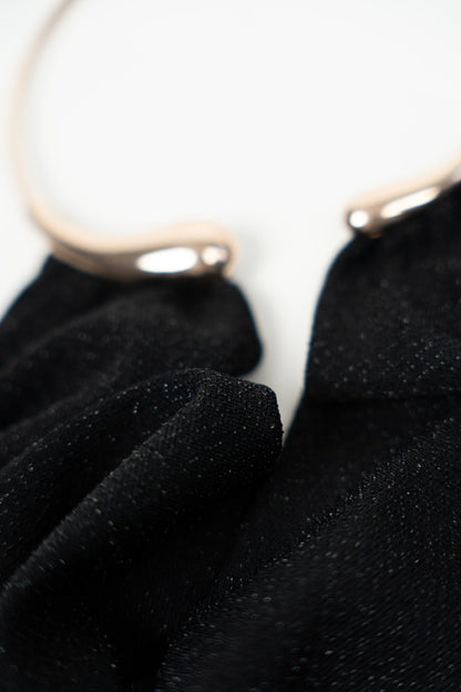 Long black dress with gold choker.