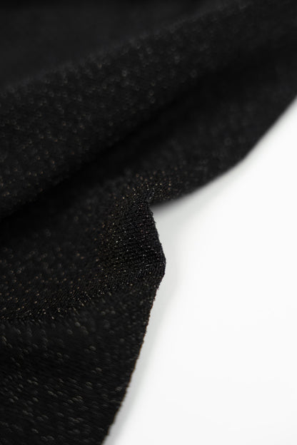 Long black dress with gold choker.