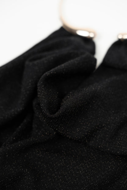 Long black dress with gold choker.