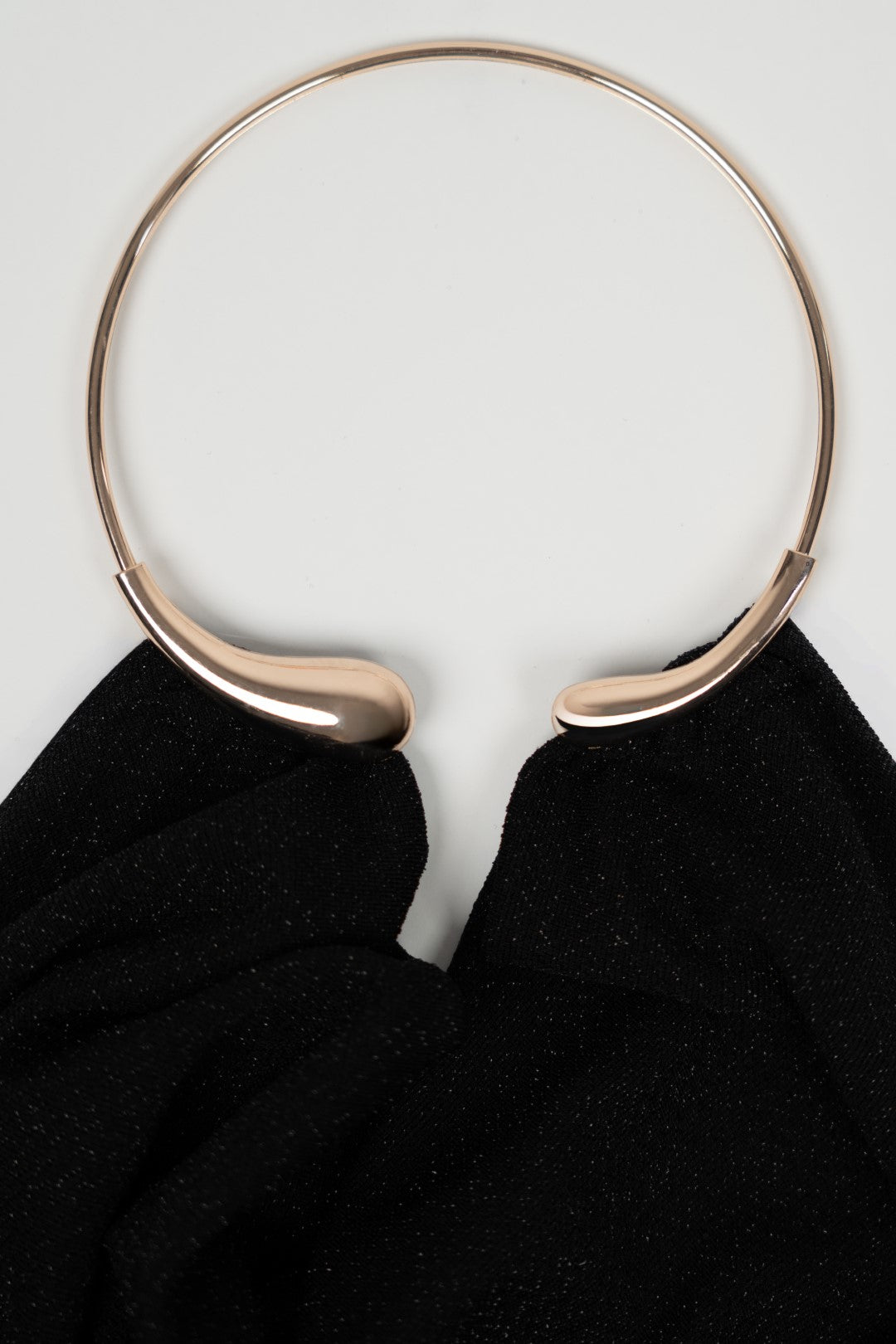 Long black dress with gold choker.