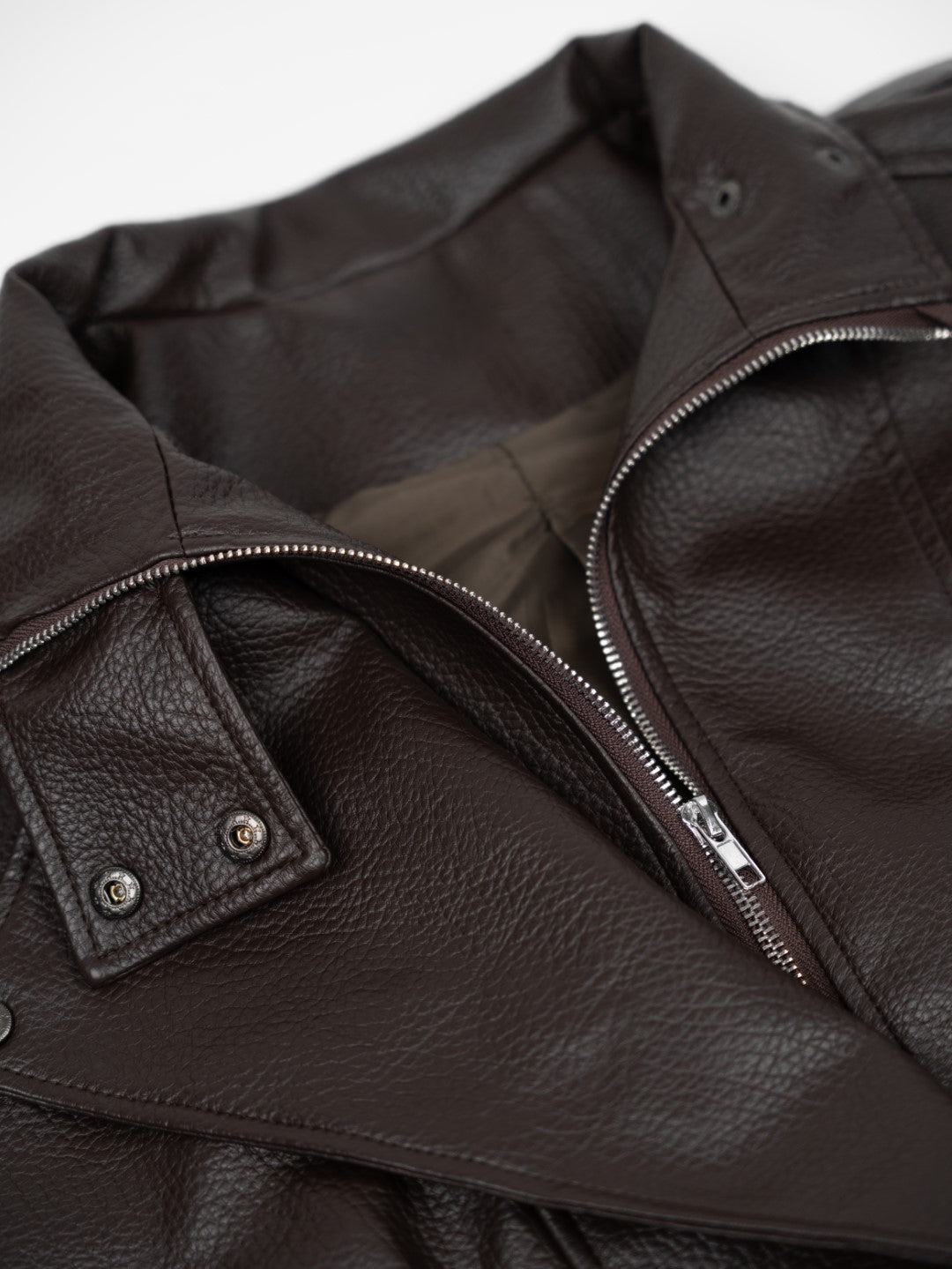 Faux leather jacket with brown collar detail.