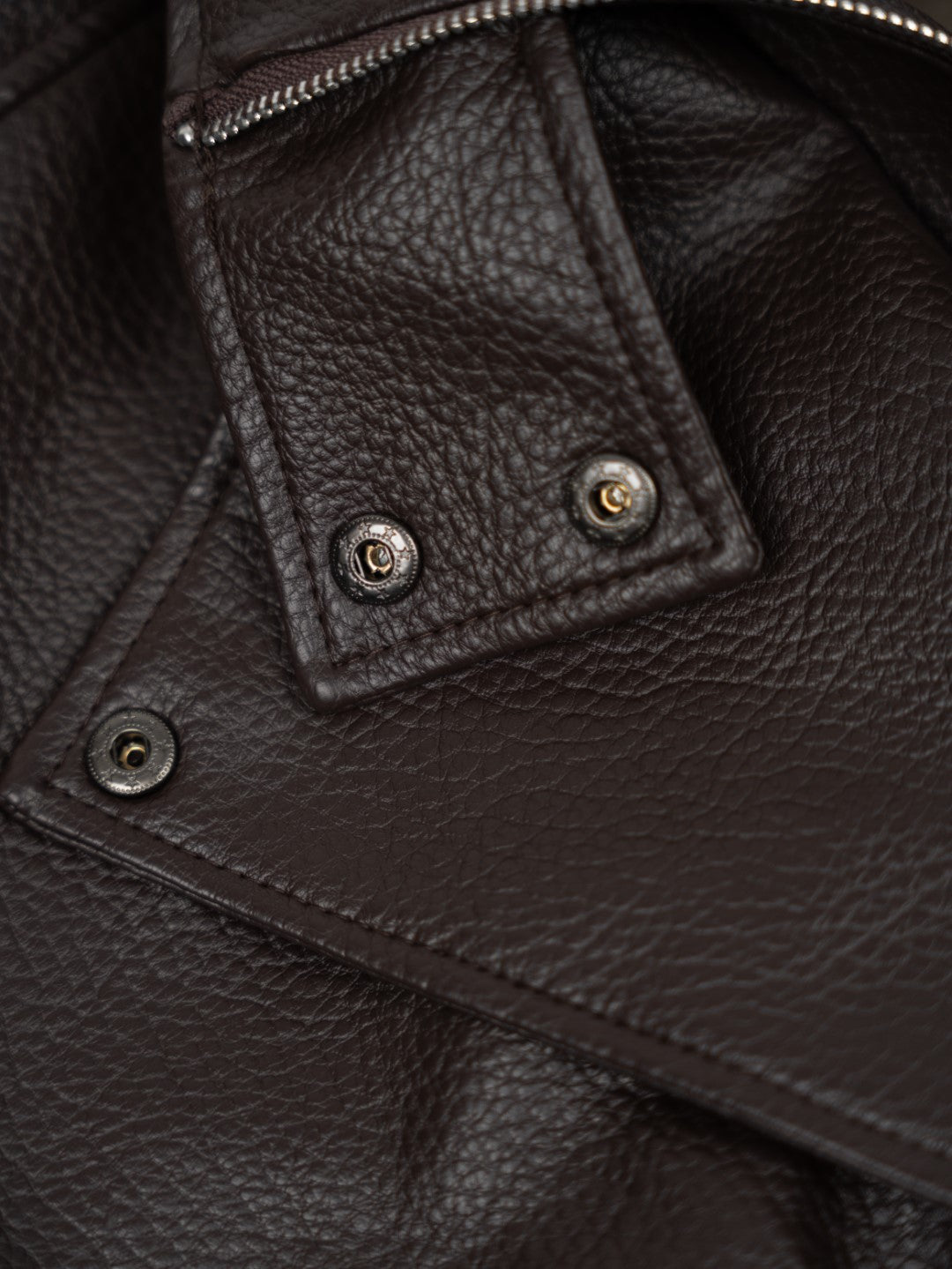 Faux leather jacket with brown collar detail.