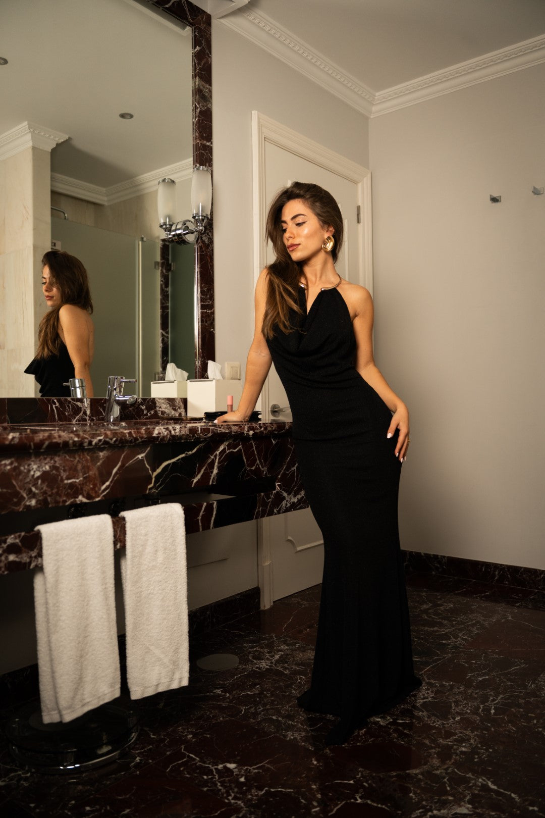 Long black dress with gold choker.