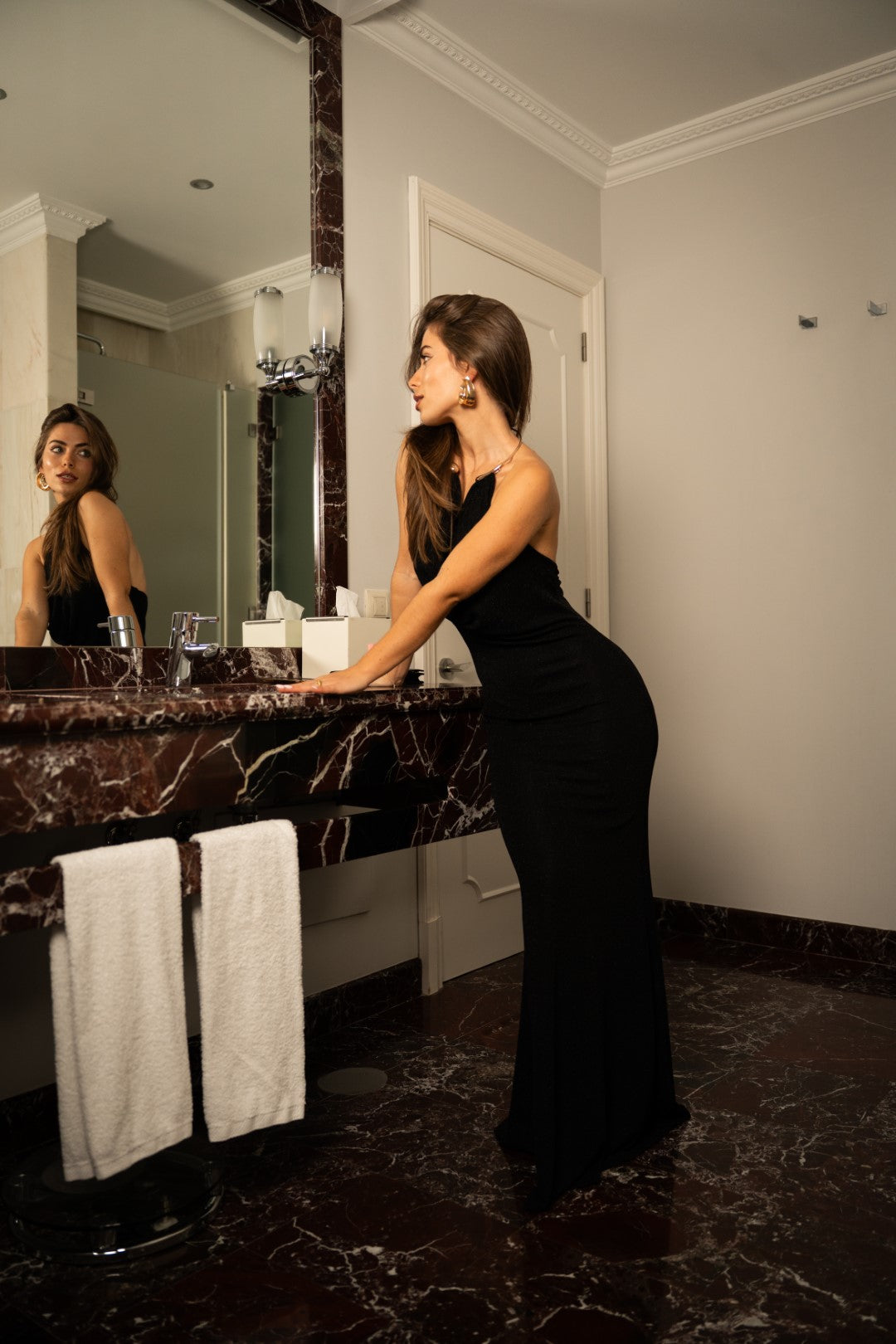 Long black dress with gold choker.