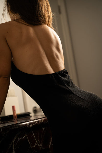 Long black dress with gold choker.