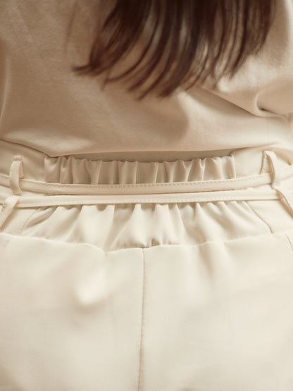 Pantaloni bianchi a gamba larga con pieghe