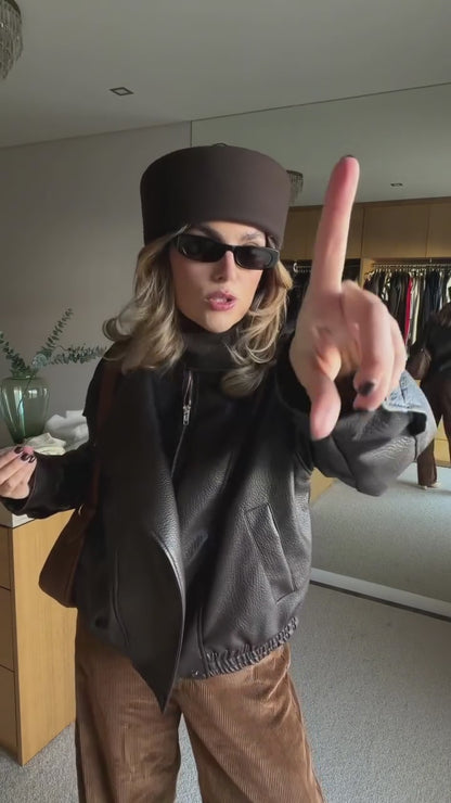 Faux leather jacket with brown collar detail.